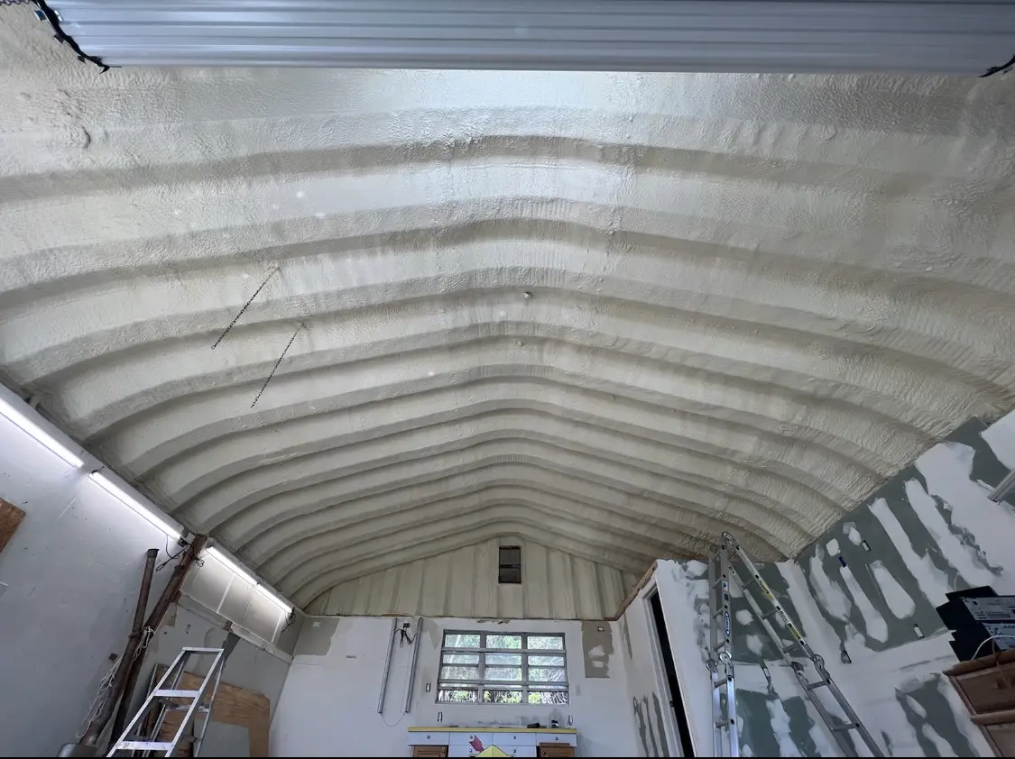 Spray polyurethane foam applied to the underside of a metal roof deck in East Greenwich